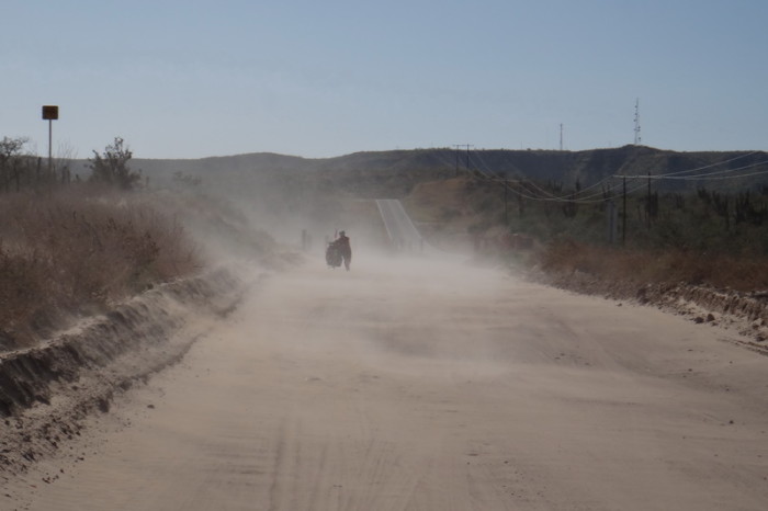 Baja California - Jo pushing her bike through the sand near La Paz