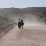 Jo pushing her bike through the sand near La Paz