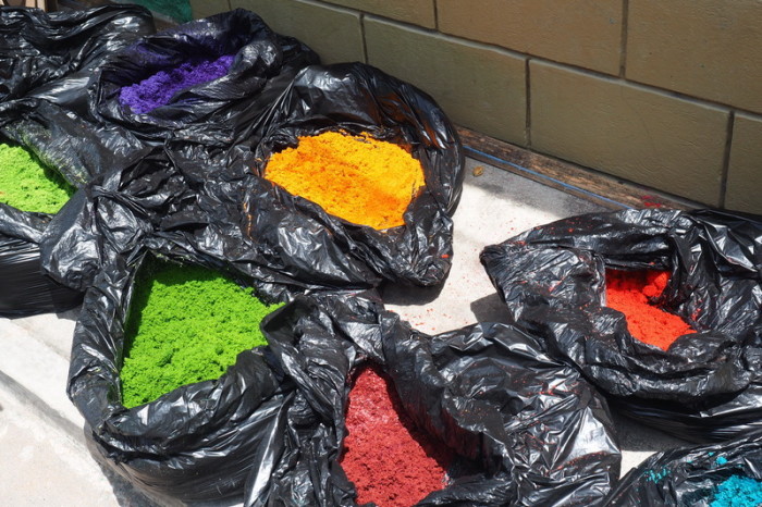 Guatemala - Bags of coloured sawdust for making the carpets, Flores, Guatemala