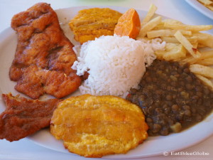 A typical Colombian lunch - chicken, 3 types of carbs (rice, fries and platano) and lentils!