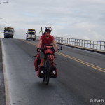 Jo cycling over the Rio Dulce Bridge