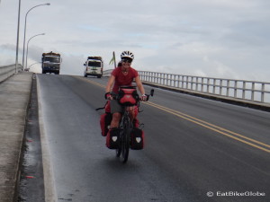 Jo cycling over the Rio Dulce Bridge