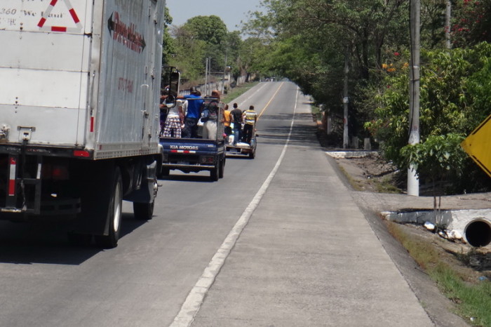 El Salvador - This is how most people get around in El Salvador - on the back of a pick up truck!