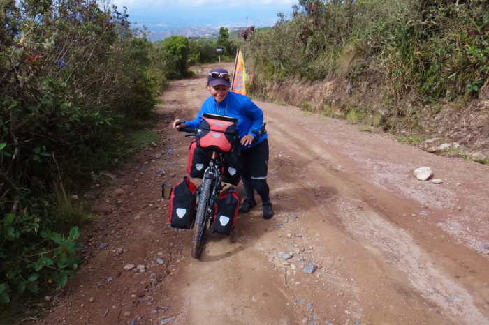 Ecuador - Jo pushing her bike up the hill from Hacienda El Hato to the highway!