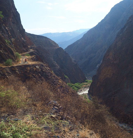 Peru - David cycling the dirt road beside the River Tablachaca
