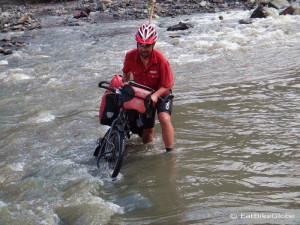 David taking Jo's bike across the river - the current was strong and the water came up to our thighs at times!