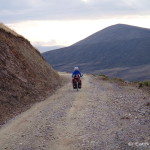Jo cycling the dirt road to Tamboras