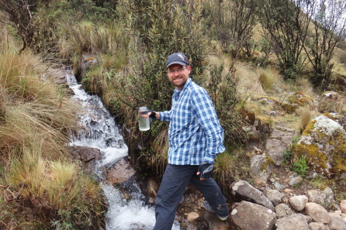 Santa Cruz Trek - David collecting water from a mountain stream