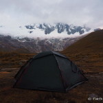 Our campsite with Mount Taulliraju in the background covered in clouds